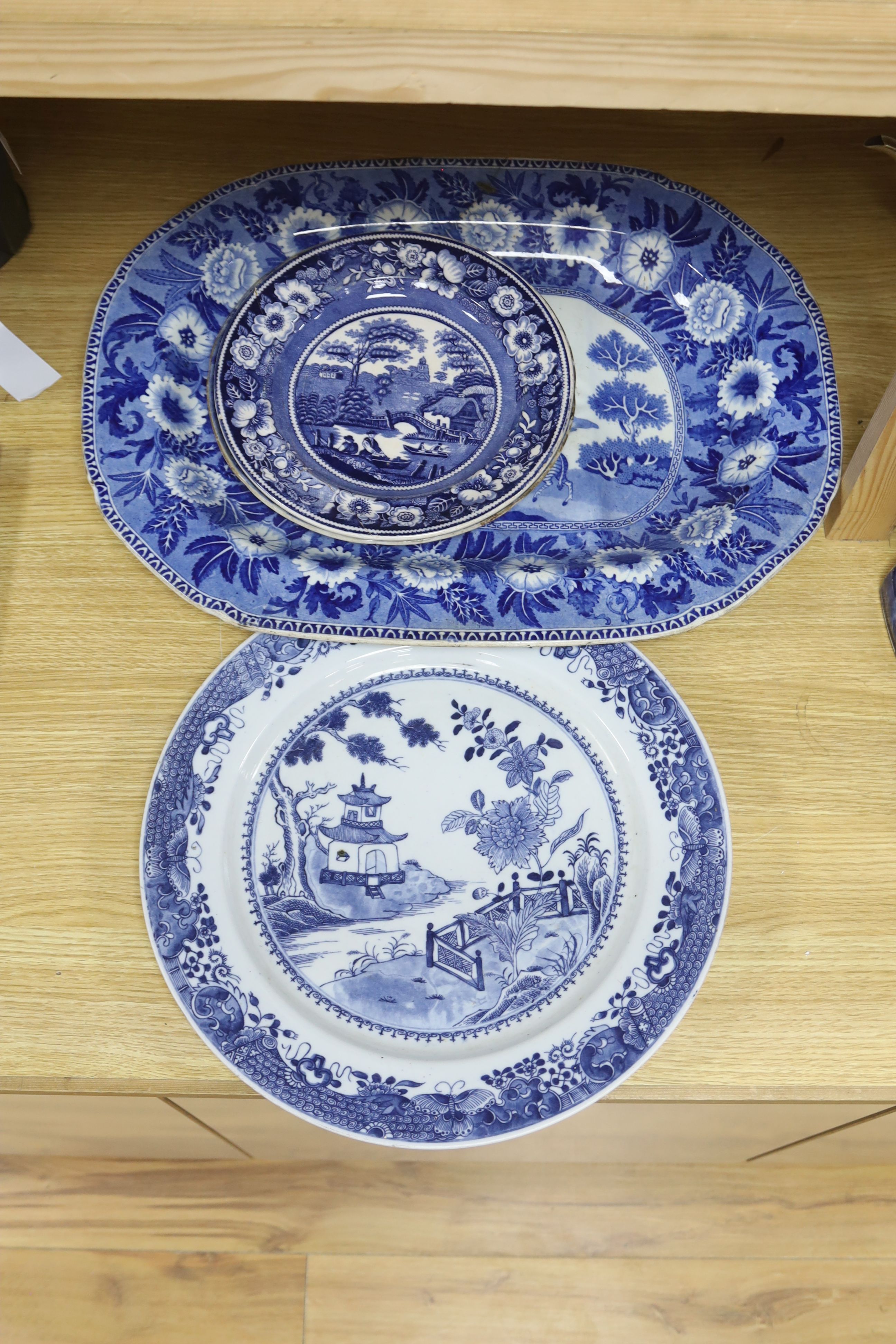 A late 19th century blue and white pottery meat dish, width 50cm, two plates and a Chinese style dish